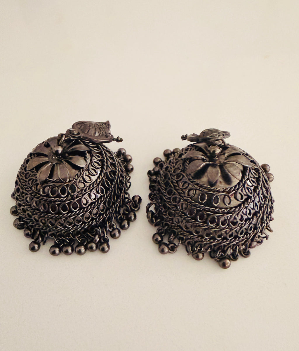Bohemian-style oxidized silver dangle earrings featuring blue rhinestone centers and beaded tassels
