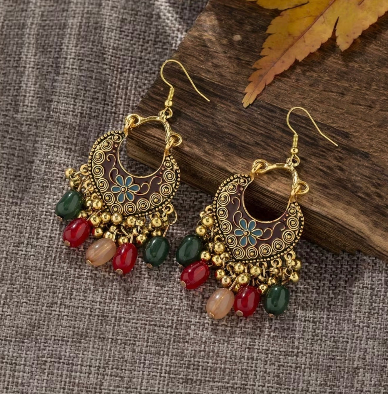 Bohemian-style oxidized silver dangle earrings featuring blue rhinestone centers and beaded tassels