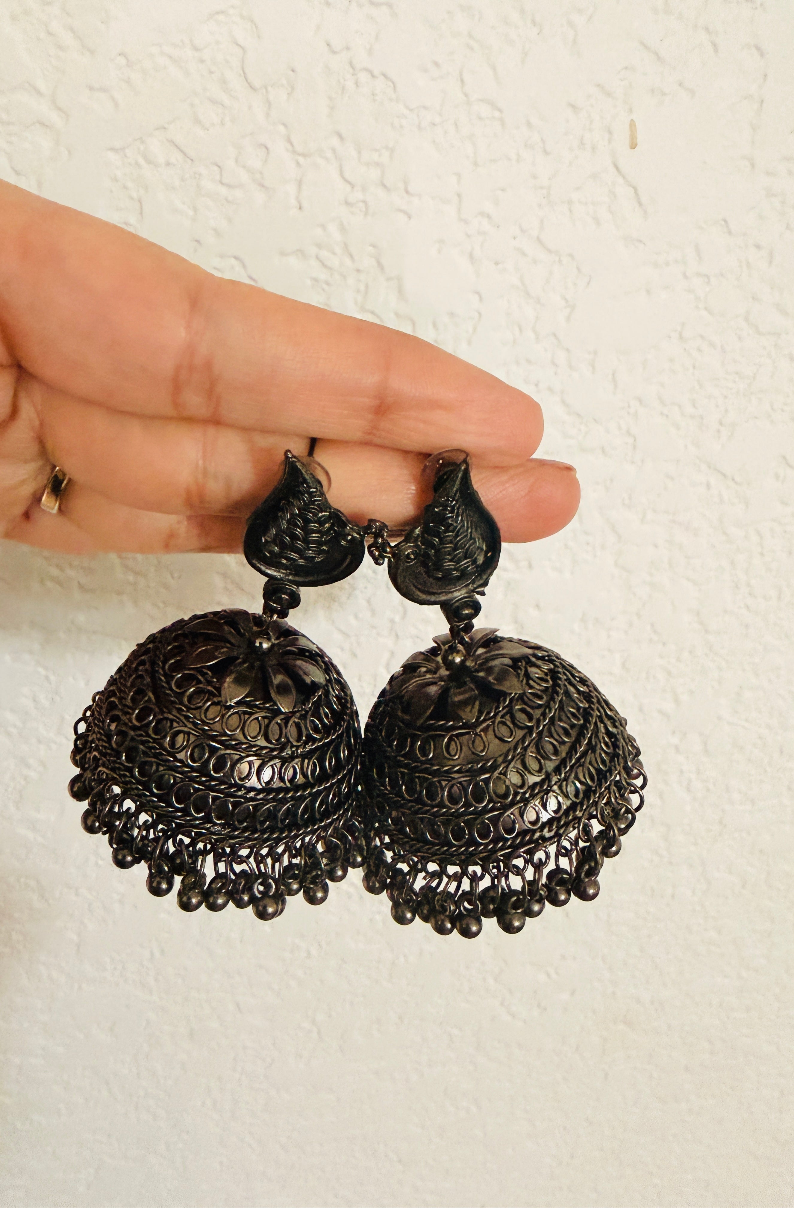 Bohemian-style oxidized silver dangle earrings featuring blue rhinestone centers and beaded tassels