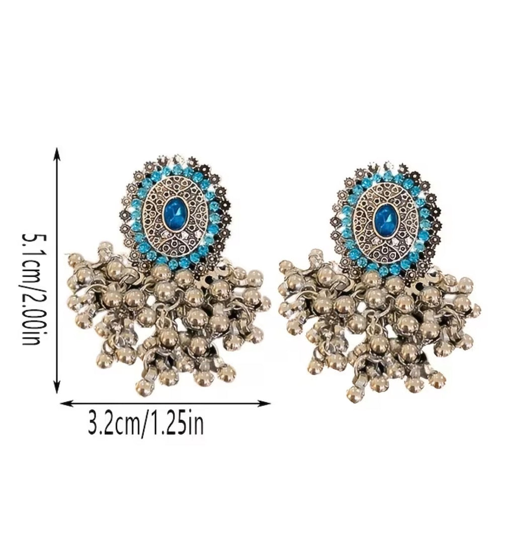 Bohemian-style oxidized silver dangle earrings featuring blue rhinestone centers and beaded tassels