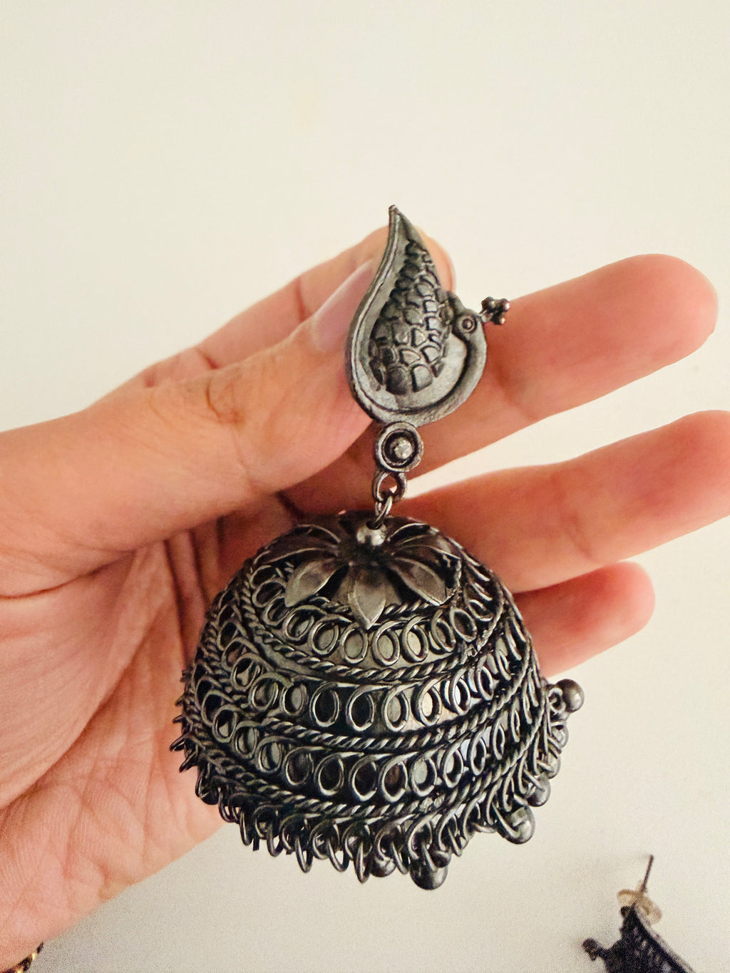 Bohemian-style oxidized silver dangle earrings featuring blue rhinestone centers and beaded tassels