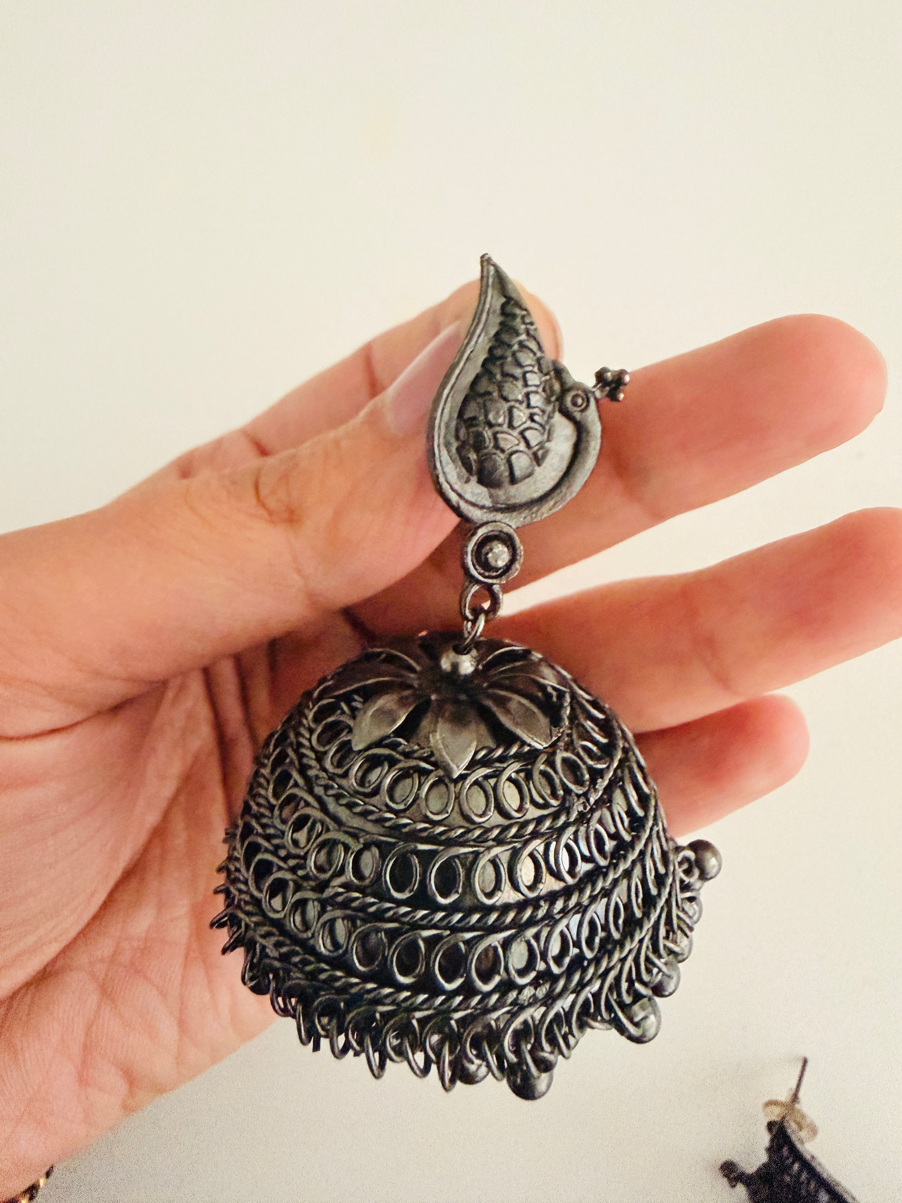 Bohemian-style oxidized silver dangle earrings featuring blue rhinestone centers and beaded tassels
