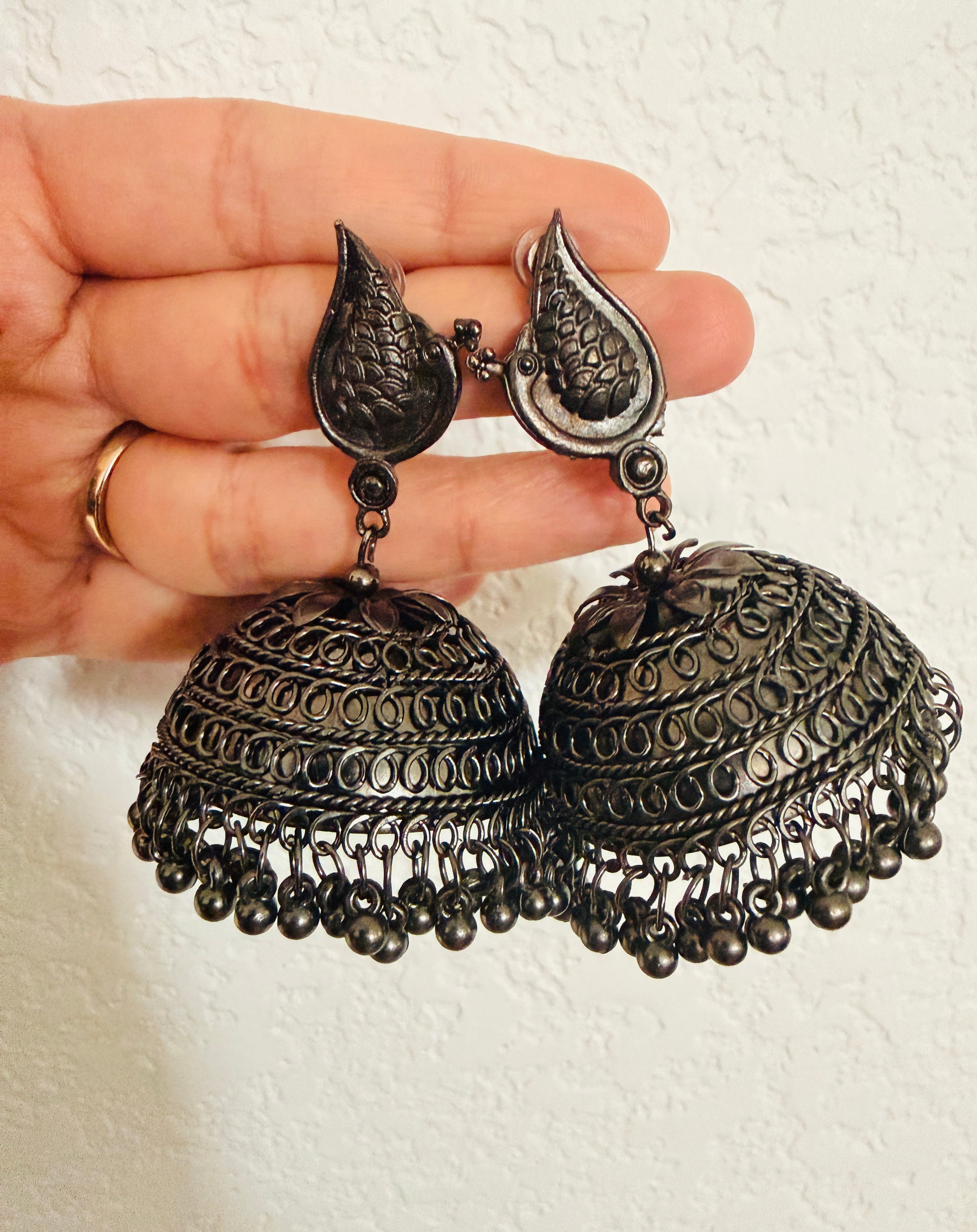 Bohemian-style oxidized silver dangle earrings featuring blue rhinestone centers and beaded tassels