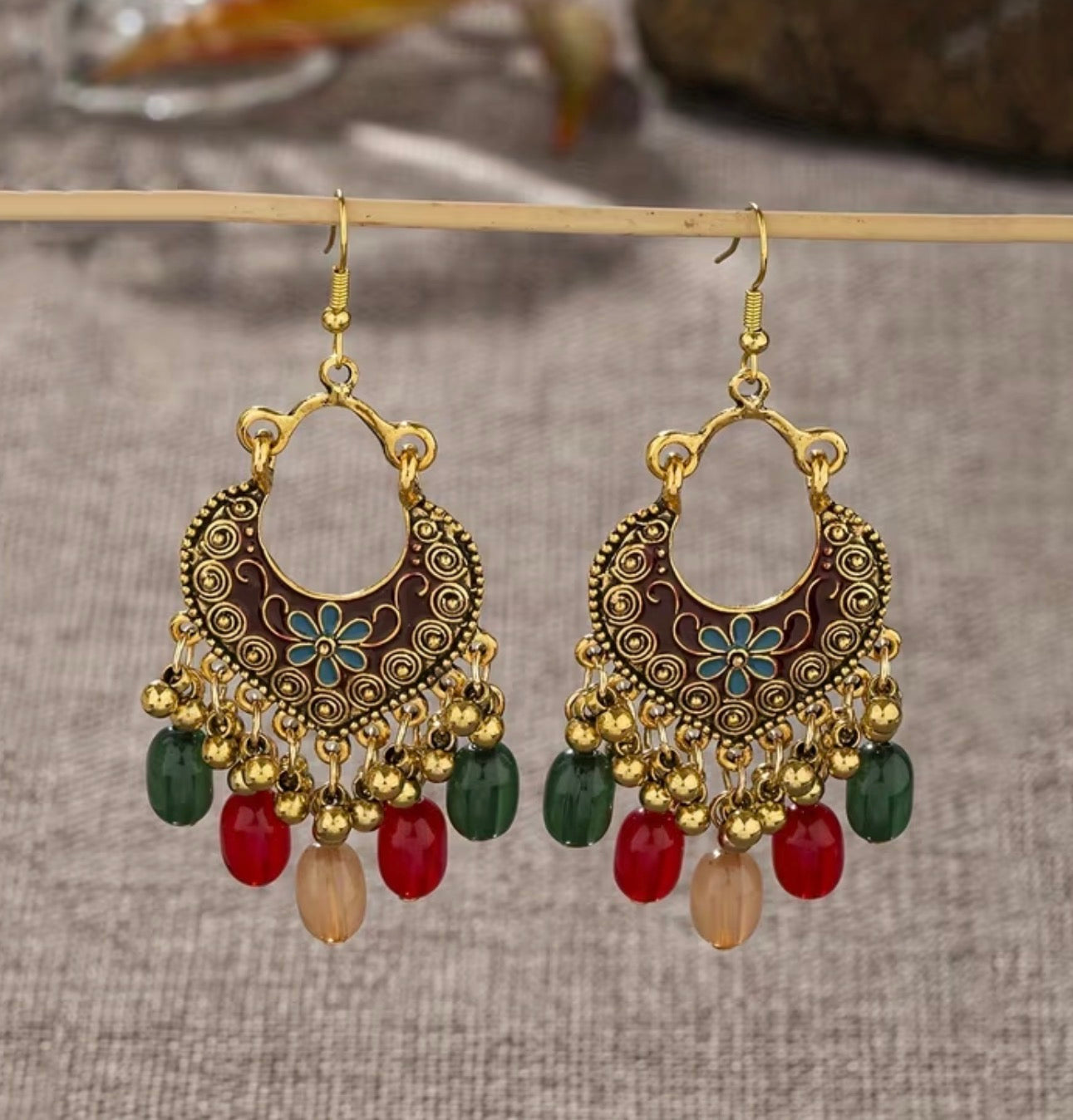 Bohemian-style oxidized silver dangle earrings featuring blue rhinestone centers and beaded tassels